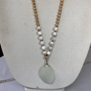 Long milky white faceted polished stone medallion necklace